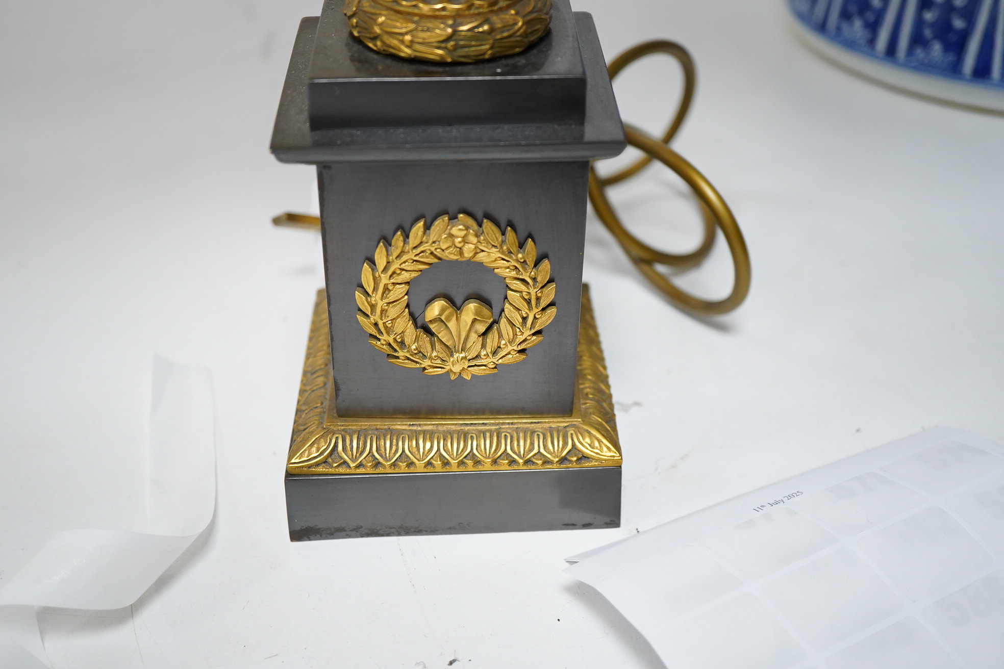 A pair of Empire style lamps with green shades